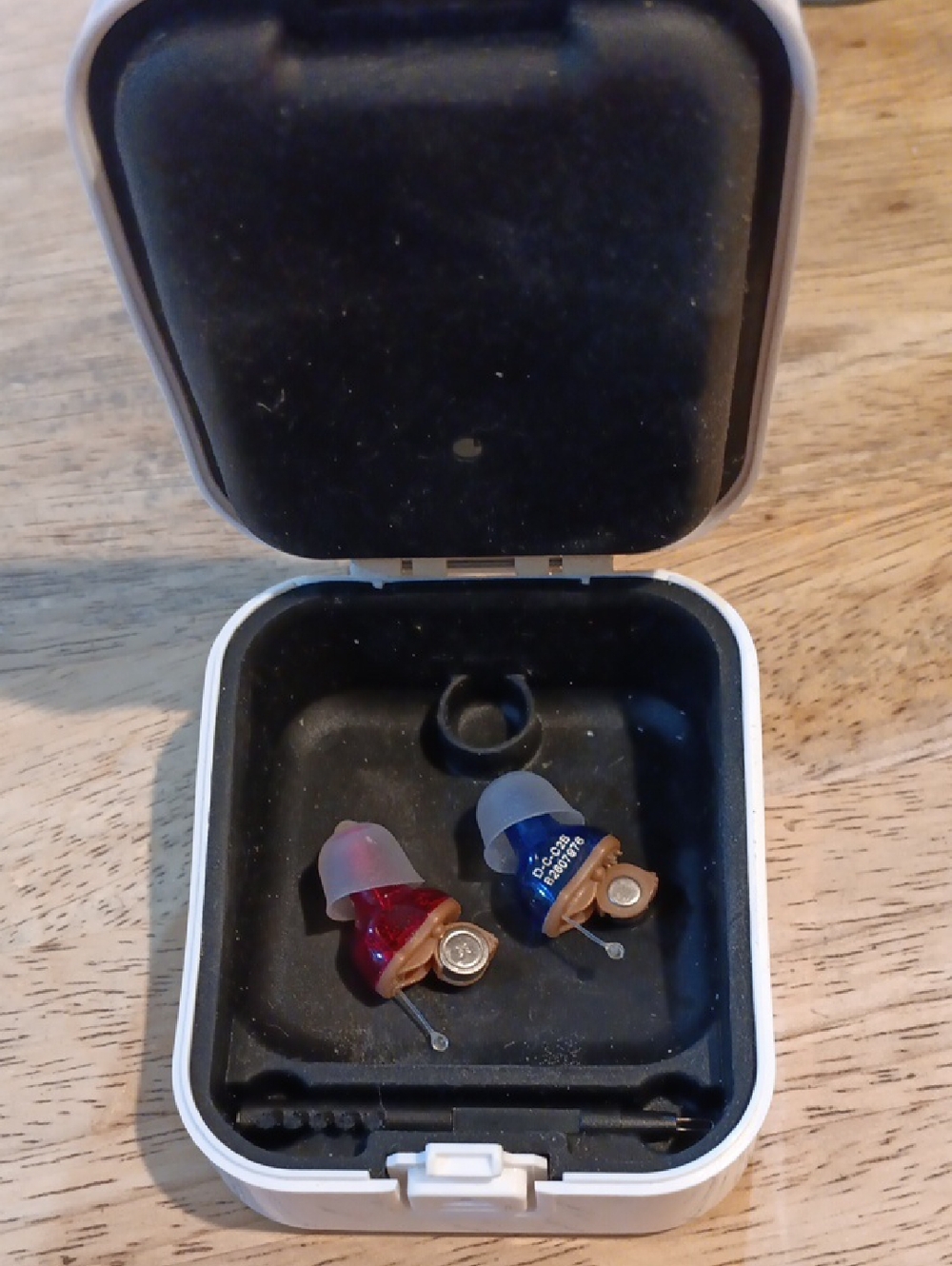 Red and Blue In-Ear Hearing Aids with Carrying Case